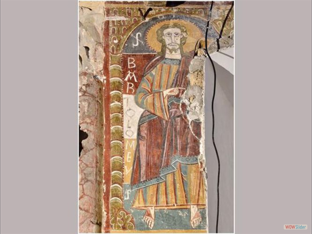 El apóstol San Bartolomé, pintado en el ábside de la iglesia de Ourjout de Les Bordes-sur-Lez, al sur de Francia. La figura aparece representado de pie bajo unas arcadas.